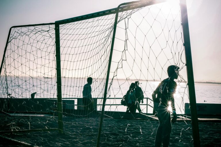 a football match being played in the evening sun